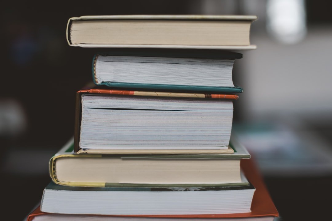 stack of paperback books desk